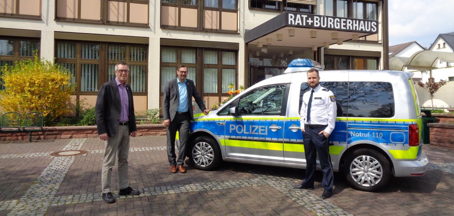 Der Schutzmann vor Ort neben seinem Polizeiauto vor dem Krifteler Rathaus.