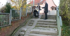 Fahrrad- und Kinderwagengerechter Zugang zum Schwarzbachweg Die Treppen zum Schwarzbachuferweg, eine Frau schiebt ihren Kinderwagen herunter.