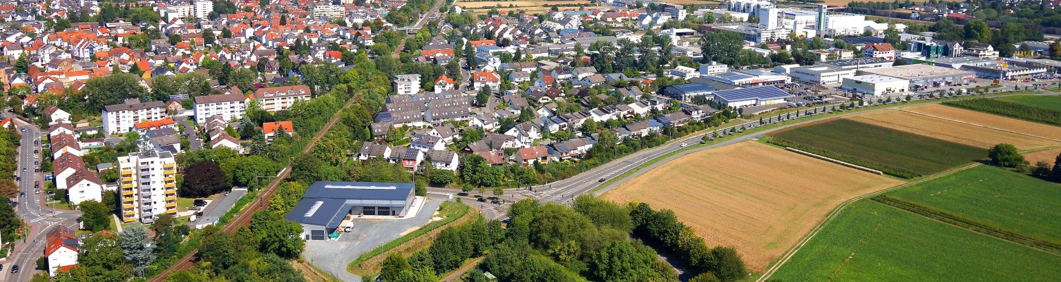 Eine Luftansicht von Kriftel - Am Horizont die Frankfurter Skyline, die Häuser von Kriftel und vorne das Hochfeld.