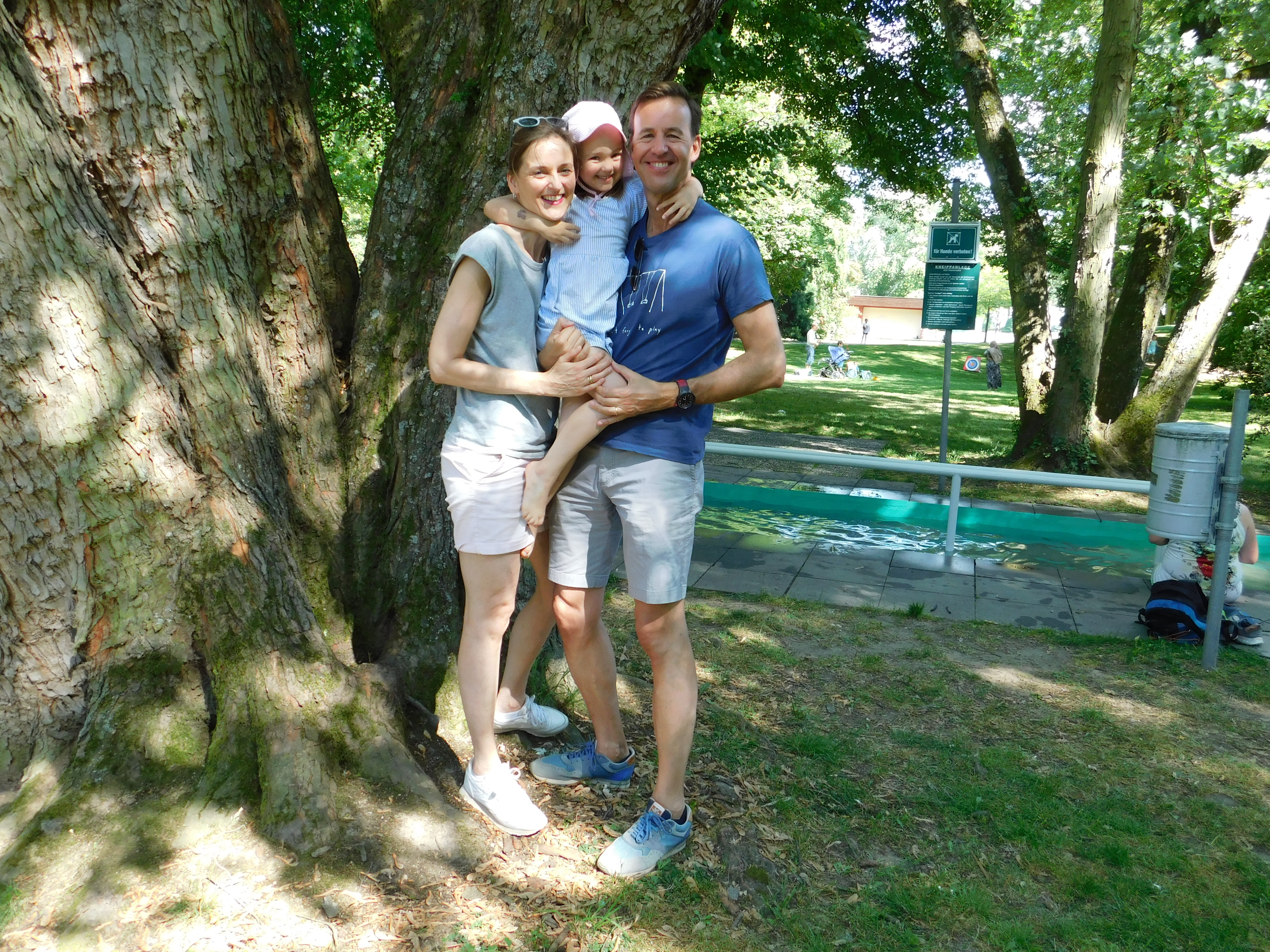 Eine lachende Familie vor dem Minigolfplatz.