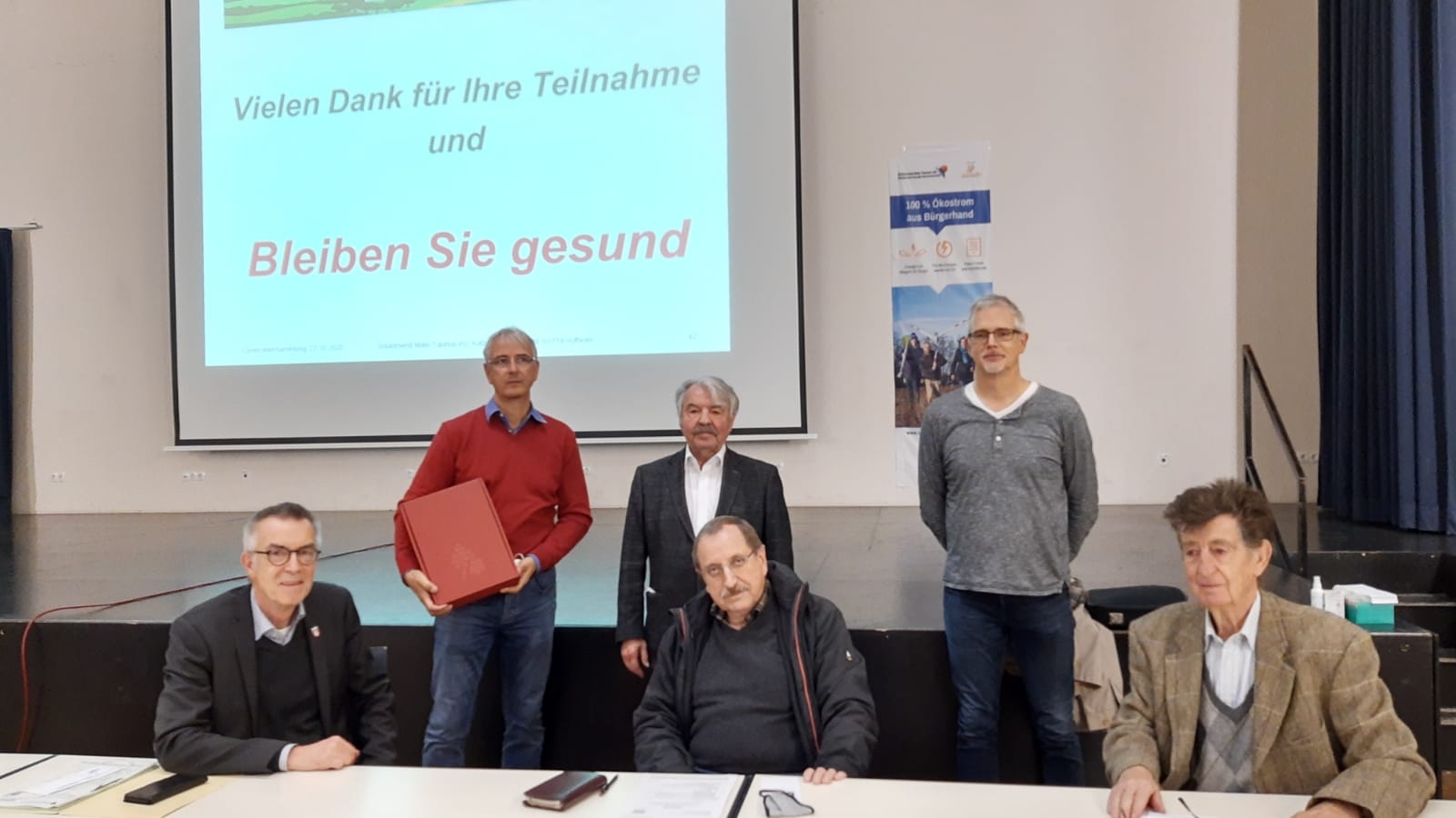 Die Mitglieder des Aufsichtsrates im Bürgerhaus Marxheim vor einer Leinwand mit Präsentation.