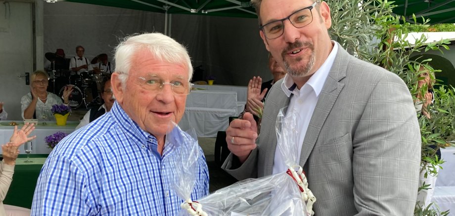 Bürgermeister Seitz übergibt ein Geschenk.