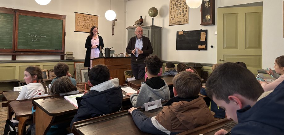 Janecke begrüßt die Kinderbeiratsmitglieder im historischen Klassenzimmer.