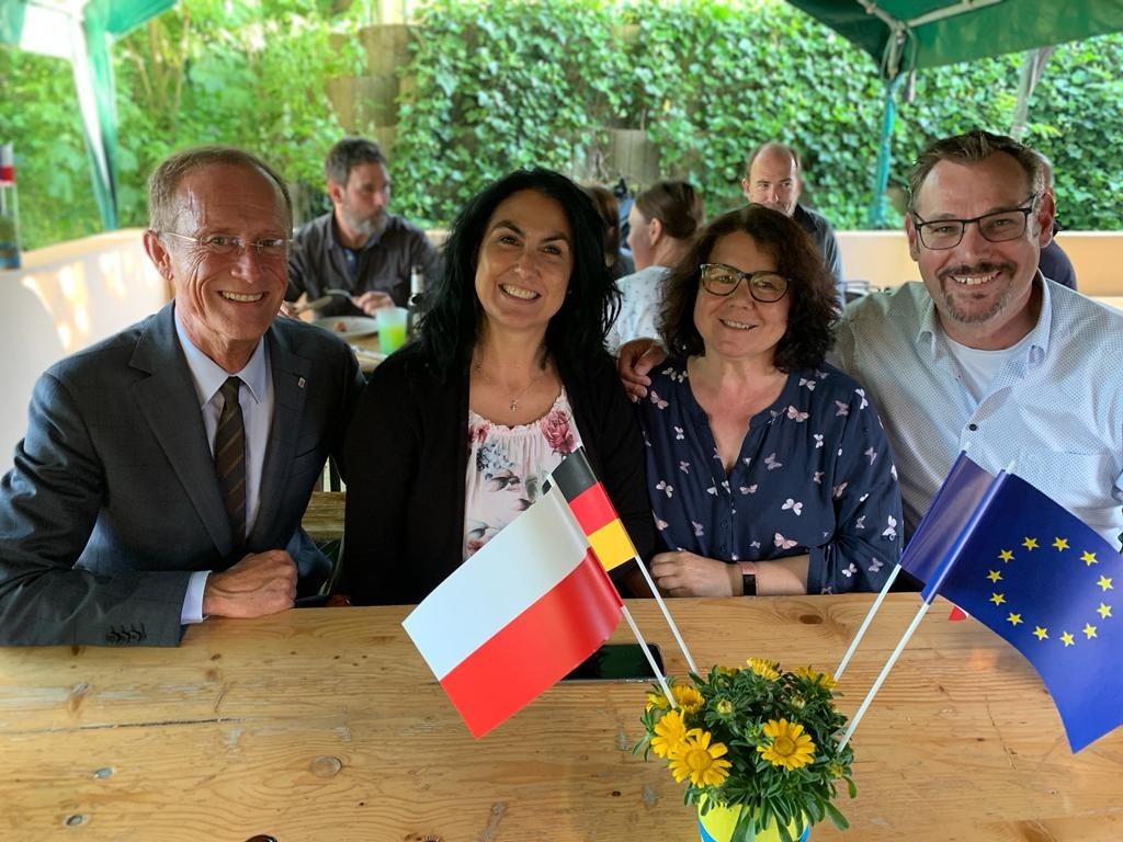 Staatsminister Wintermeyer. Bürgermeister Seitz und Damen des Ausländerbeirates mit Fähnchen.