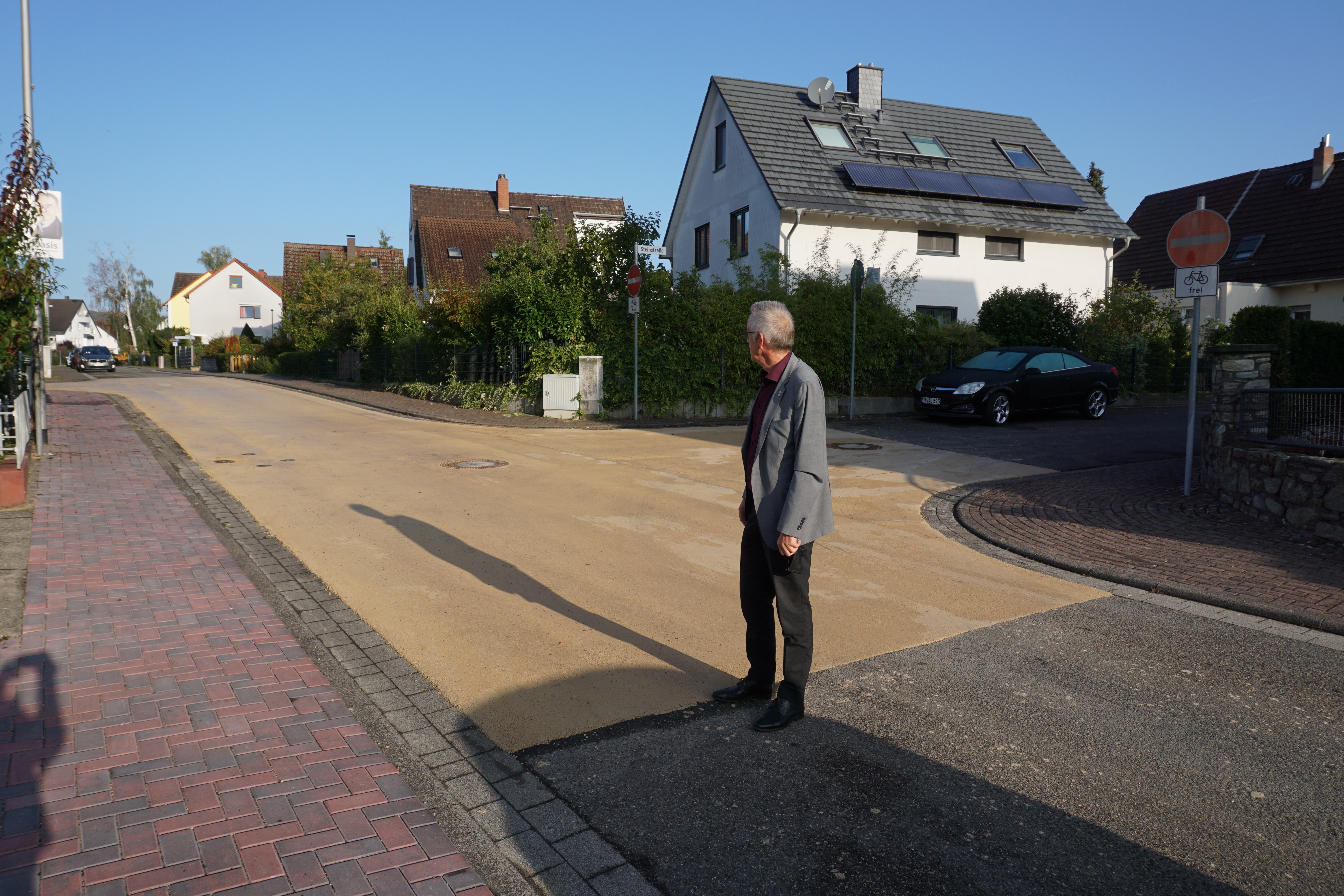 Beiger Straßenbelag an einer Kreuzung.