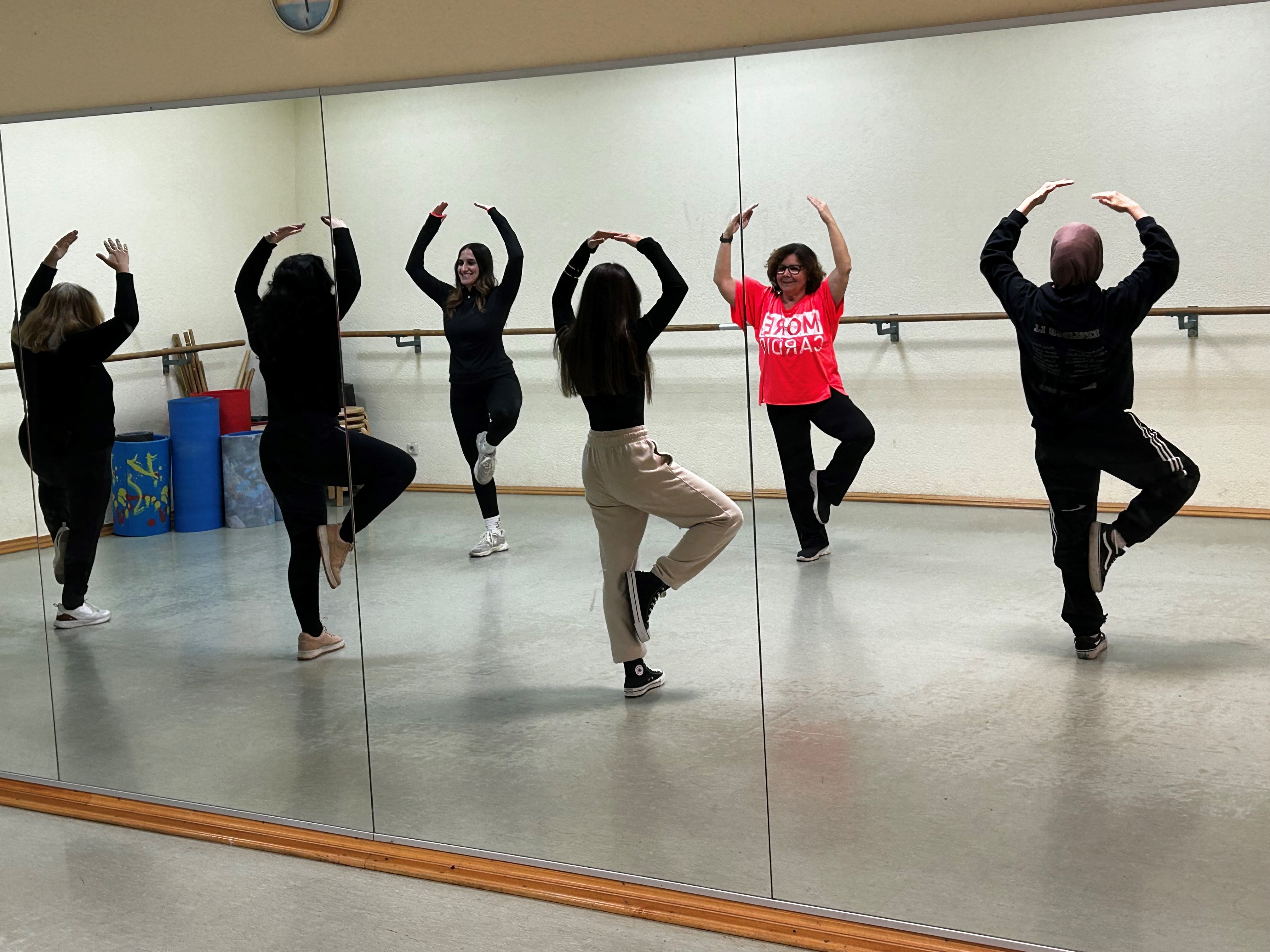 Tänzerinnen im Spiegelsaal auf einem Bein.