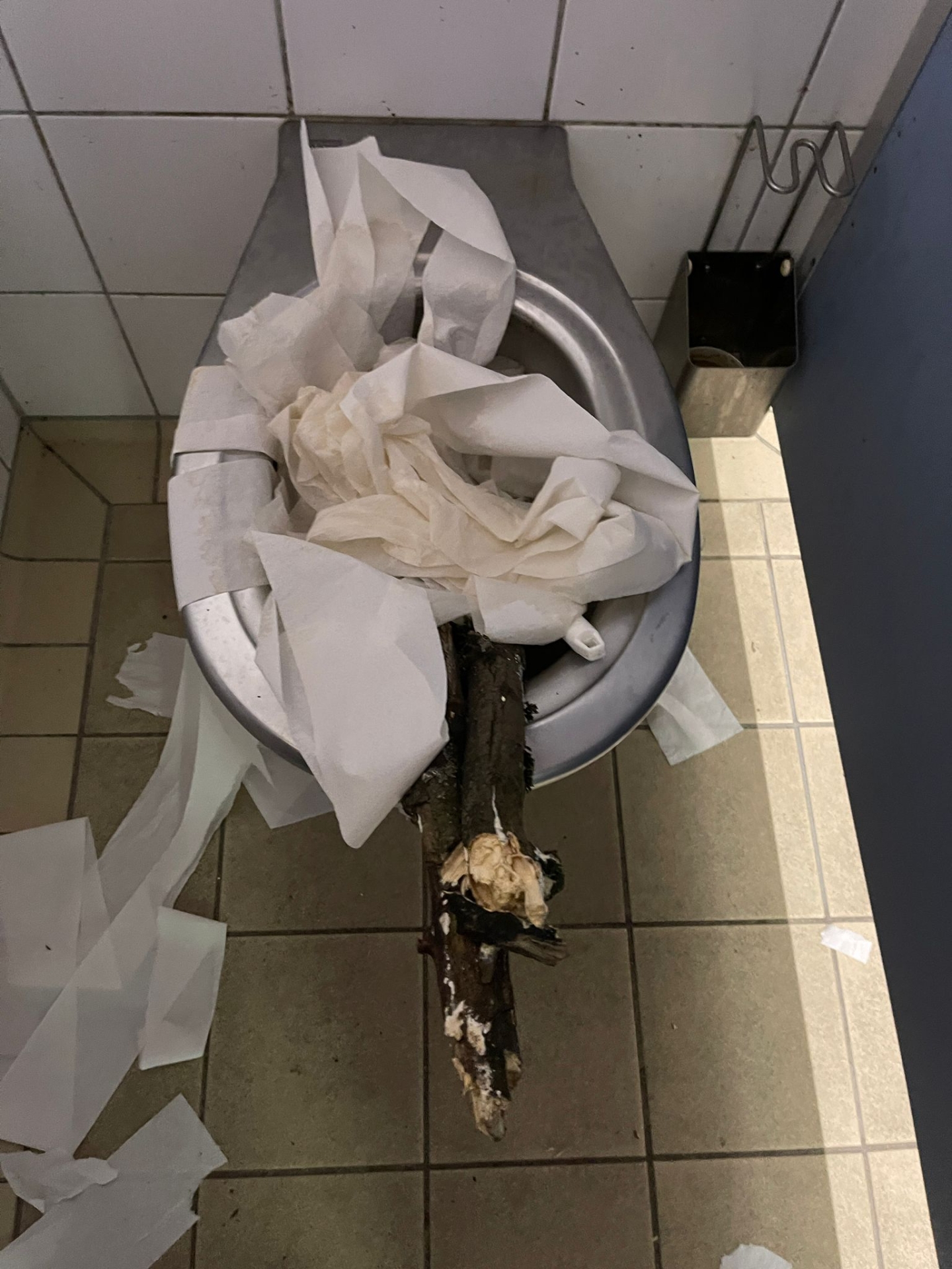 Eine verstopfte Toilette mit Papier und Holz.