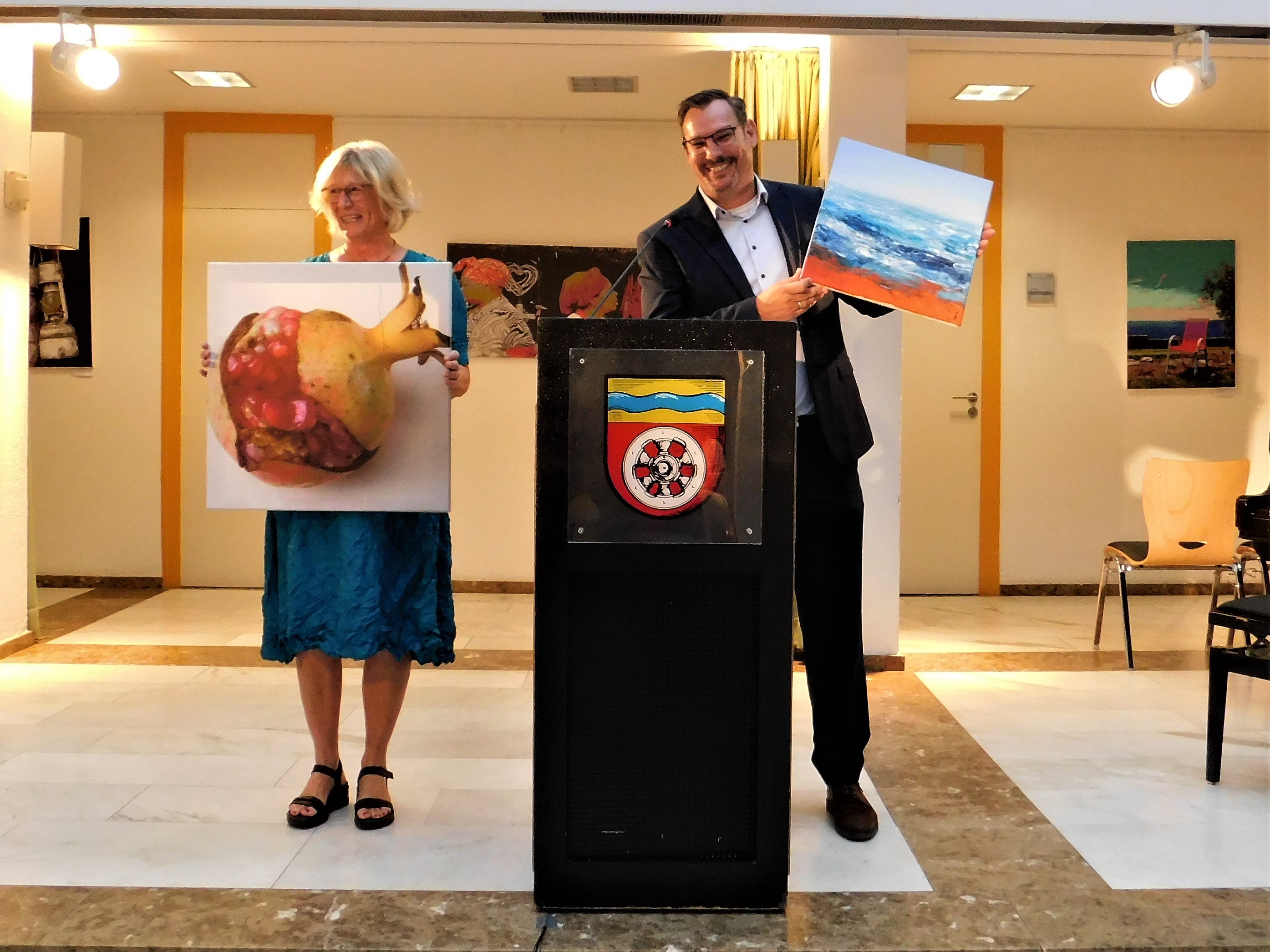 Seitz und Franke halten Bilder in der Hand.