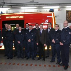 Gruppenbild von der Jahreshauptversammlung vor einem Feuerwehr-Einsatzfahrzeug